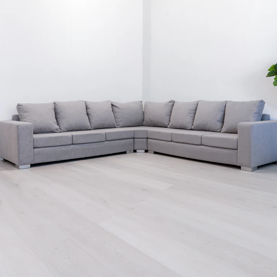 Grey corner sofa in a bright, empty room