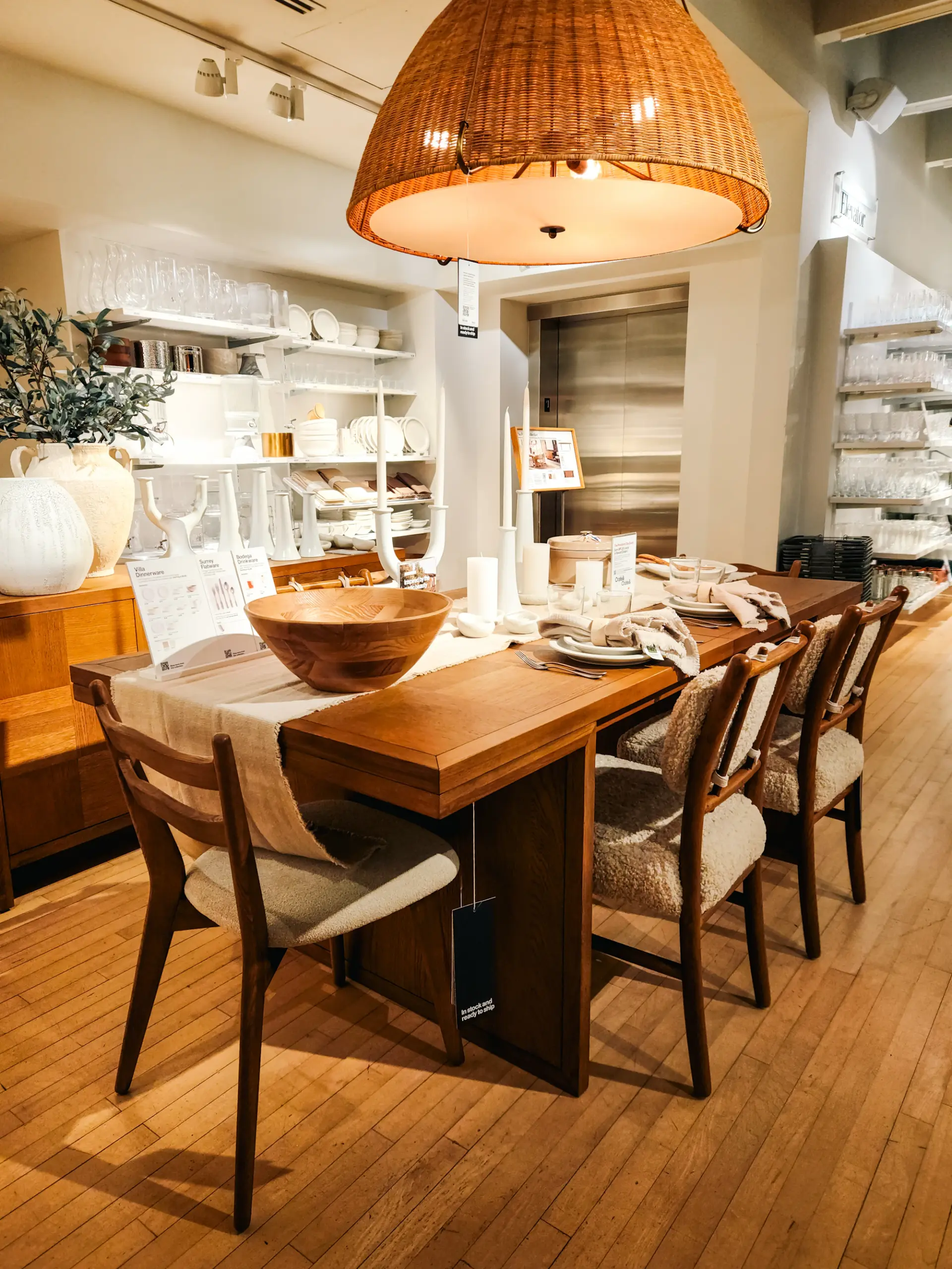 Dining room with a wooden table, chairs and a woven pendant lamp