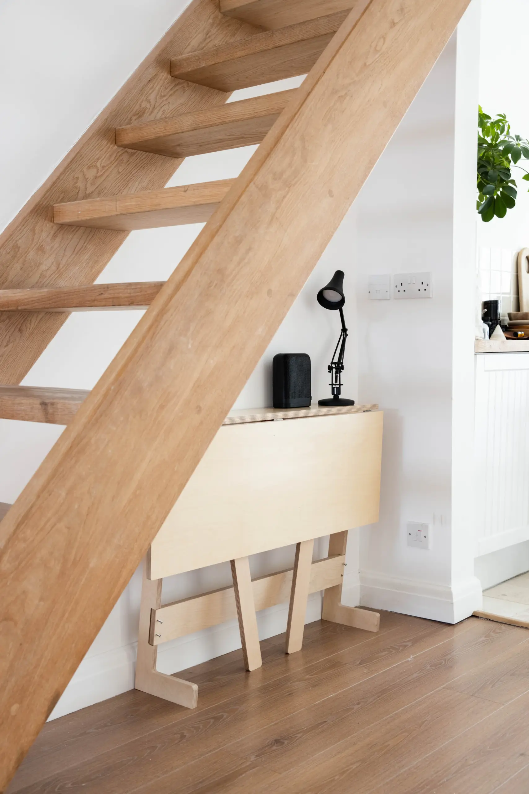 Narrow space with an open oak staircase and a fold-down desk