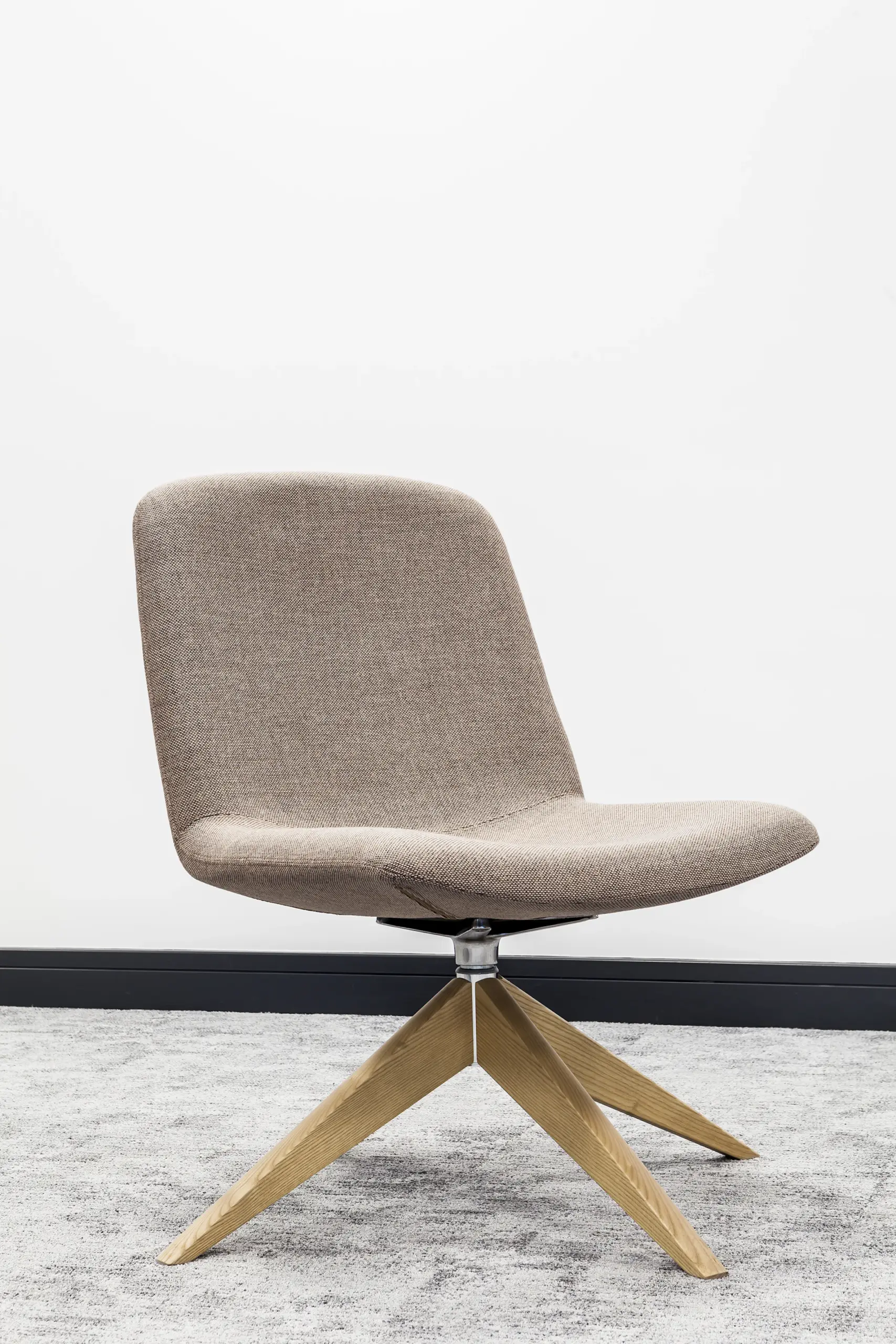 Light grey upholstered swivel chair on an oak star base